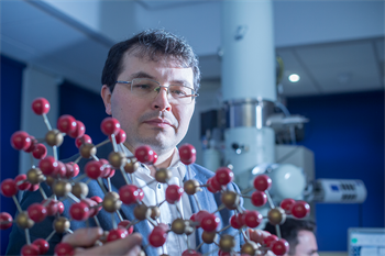 Andrei Khlobystov holding a stick and ball model of a chemical structure